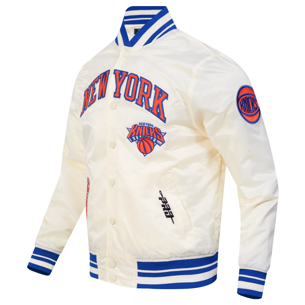 NBA NEW YORK KNICKS CITY EDITION 25-26 MEN'S PRO SATIN YD RIB JACKET (EGGSHELL/ROYAL BLUE)